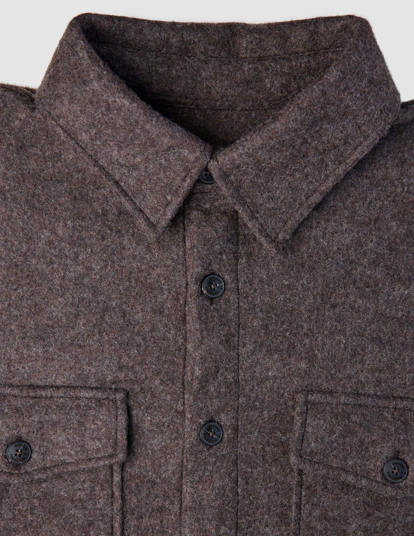 Close-up of a Double Layer Wool Overshirt Saddle Brown, featuring a brown wool design with a pointed collar, button-down front, and two buttoned chest pockets.
